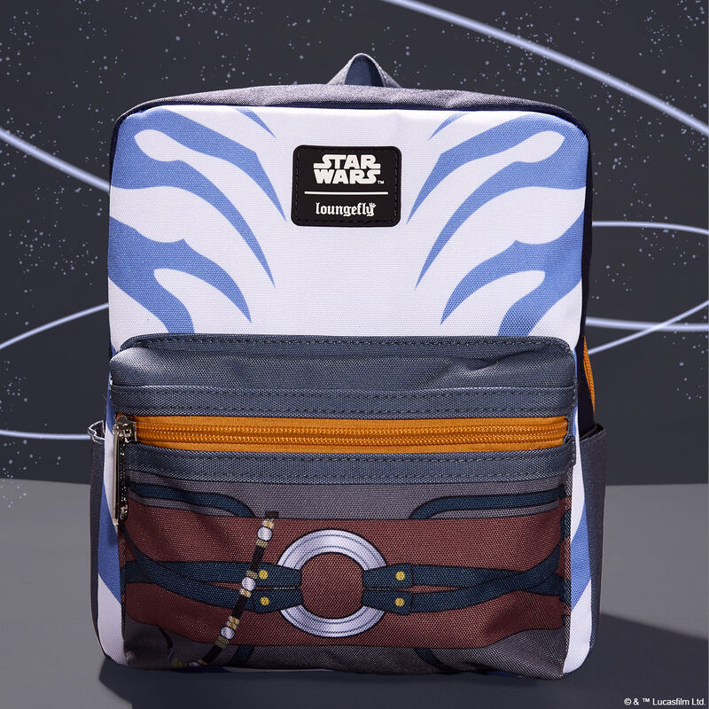 Nylon Loungefly Ahsoka mini backpack that features the same design as Ahsoka's lekku on the top part of the bag and an image of her belt on the front pocket. The bag sits against a dark blue background with swooping white stripes. 